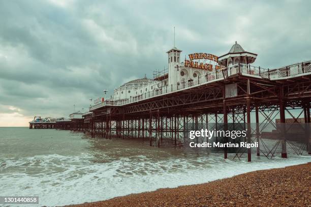 brighton palace pier and brighton beach, united kingdom - brighton pier stock pictures, royalty-free photos & images