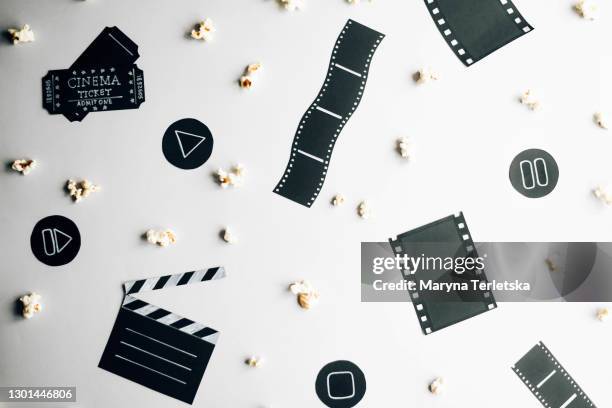 cinema paraphernalia and popcorn on a gray background. - victor ovies stock pictures, royalty-free photos & images