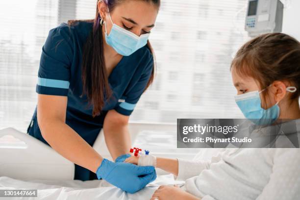 the sick child in the hospital bed , wearing a protective face mask - pediatric intensive care unit stock pictures, royalty-free photos & images