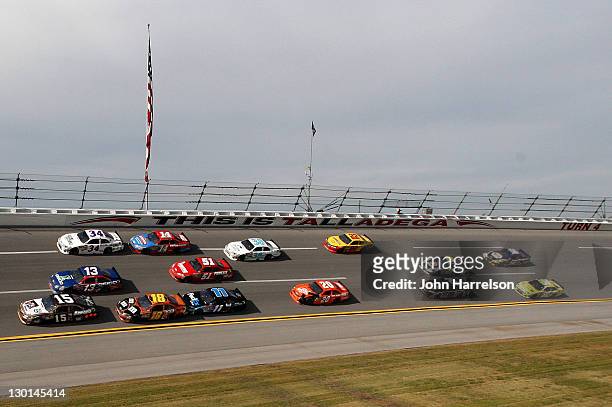 Michael Waltrip, driver of the Aaron's Dream Machine/Darrell Waltrip NASCAR Hall of Fame Toyota, leads a pack of cars during the NASCAR Sprint Cup...