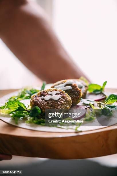 falafel served on wrapped bread - middle eastern food stock pictures, royalty-free photos & images