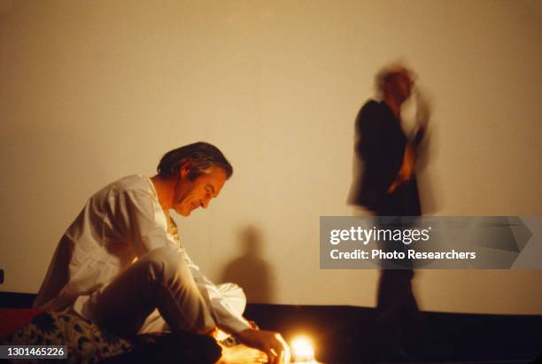 View of American psychologist Dr Timothy Leary as he sits on the floor during an unspecified event at Harvard University, Cambridge, Massachusetts,...