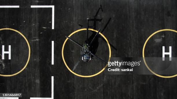 military helicopter at helipad. directly above. - helicopter blades stock pictures, royalty-free photos & images