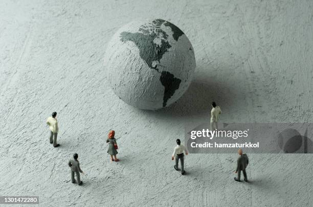 globe 1 - figurine people stock pictures, royalty-free photos & images