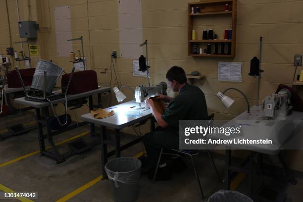 Prisoner works sewing uniforms while serving her sentence at a "shock" camp prison run by the New York State Department of Corrections, in October of...