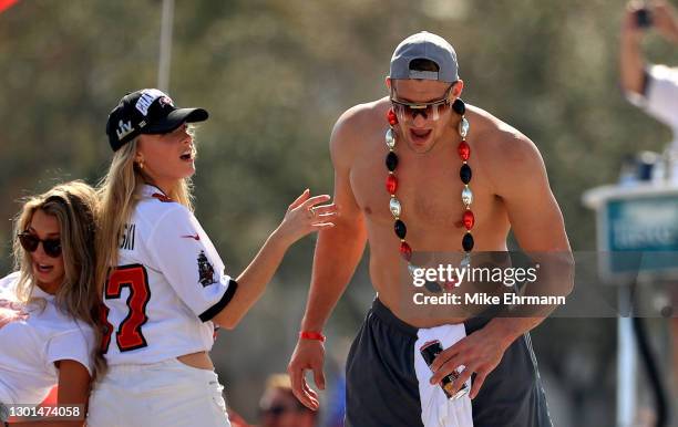 Rob Gronkowski of the Tampa Bay Buccaneers and girlfriend Camille Kostek celebrates their Super Bowl LV victory during a boat parade through the city...