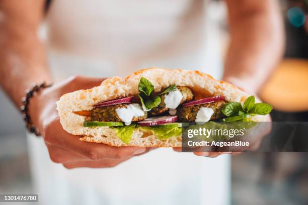 falafel and fresh vegetables in pita bread - pitta bread stock pictures, royalty-free photos & images