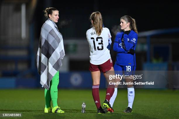 Ann-Katrin Berger of Chelsea wrapped in a blanket and Maren Mjelde of Chelsea chatr with Lia Walti of Arsenal during the Barclays FA Women's Super...