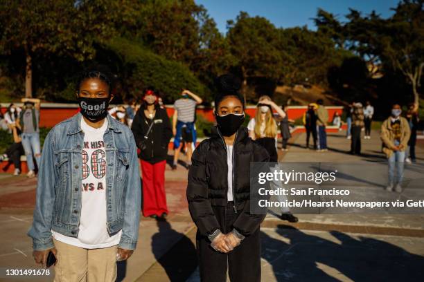 Lowell High School freshmen Hannah Chikere and Arianna Grice listen during a press conference to address recent racist attacks on the Lowell...