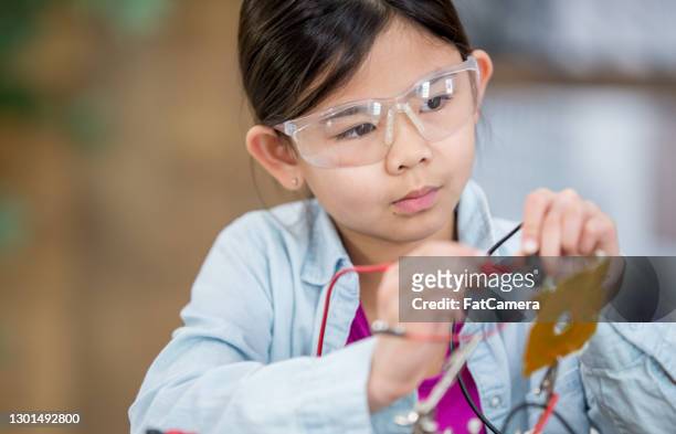 elementary girl using circuit board and electrical wires - school science project stock pictures, royalty-free photos & images