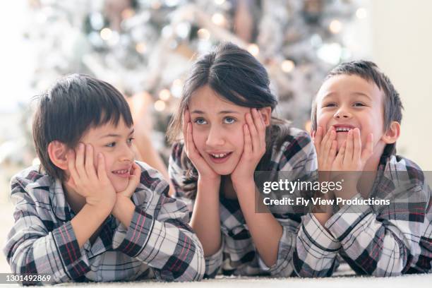 cute mixed race siblings on christmas morning - portland oregon christmas stock pictures, royalty-free photos & images