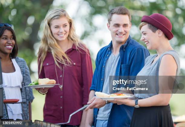 grilling some burgers with my friends - canada day party stock pictures, royalty-free photos & images