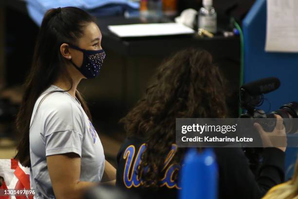 Bruins graduate assistant coach and former athlete Kyla Ross looks on ahead of a meet between the Bruins and the BYU Cougars at Pauley Pavilion on...