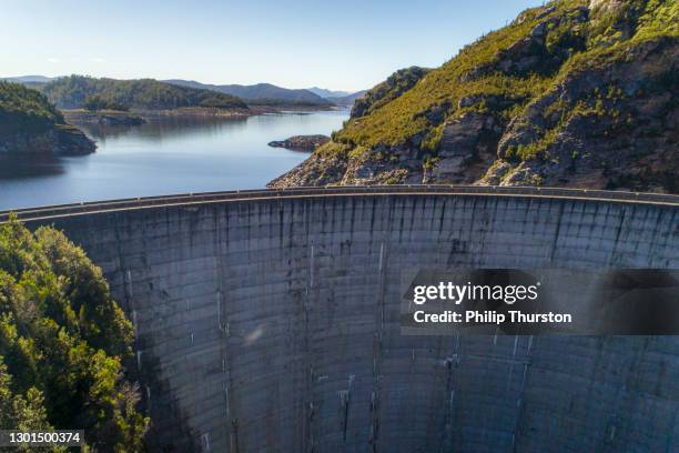 cement dam wall creating hydro electricity aerial view - hydroelectric dam stock pictures, royalty-free photos & images