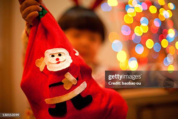 christmas sock holding by  little boy - kid stocking stock pictures, royalty-free photos & images