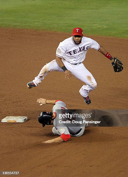 Elvis Andrus of the Texas Rangers turns the double play as Lance Berkman of the St. Louis Cardinals slides into second base in the fifth inning...