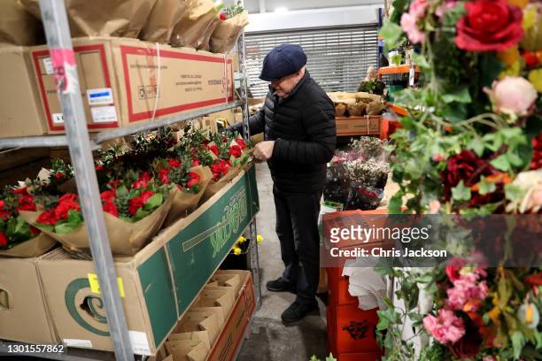Flowers trades-people work at Covent Garden Market early in the morning on February 11, 2021 in London, England. New Covent Garden market is the...