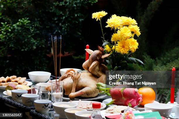 many dishes and boil chicken on table for worshiping on last day of lunar year in vietnam - viburnum stock-fotos und bilder