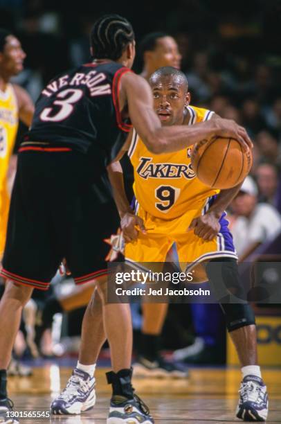 Nick Van Exel, Point Guard for the Los Angeles Lakers keeps his eyes on the advancing Allen Iverson of the Philadelphia 76ers during their NBA...