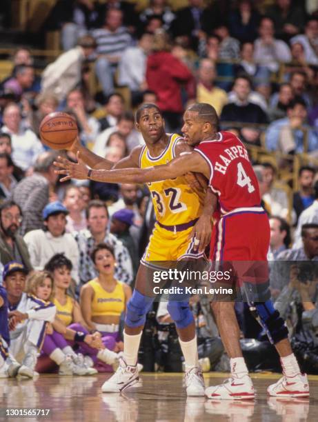 Earvin "Magic" Johnson, Shooting Guard and Power Forward for the Los Angeles Lakers is blocked by Ron Harper, Point Guard and Shooting Guard for the...