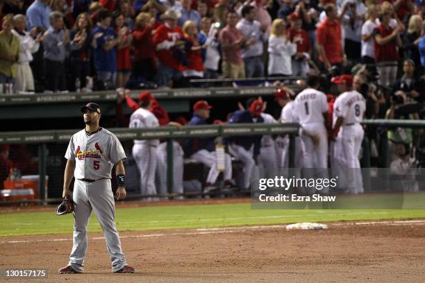 Albert Pujols of the St. Louis Cardinals reacts after a three-run home run by Mike Napoli of the Texas Rangers in the sixth inning during Game Four...