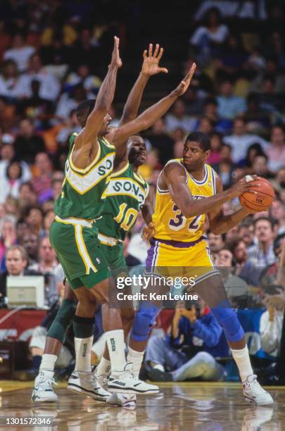 Earvin "Magic" Johnson, Shooting Guard and Power Forward for the Los Angeles Lakers is blocked by Nate McMillan, Point Guard and Shooting Guard for...