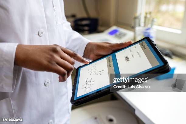 scientist using digital tablet in lab - lab closeups stock-fotos und bilder