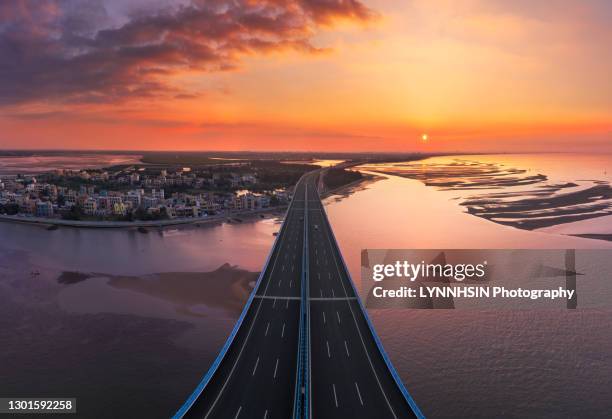 wenchang qinglan bridge towards to the sunset aeroshot - wenchang stock pictures, royalty-free photos & images