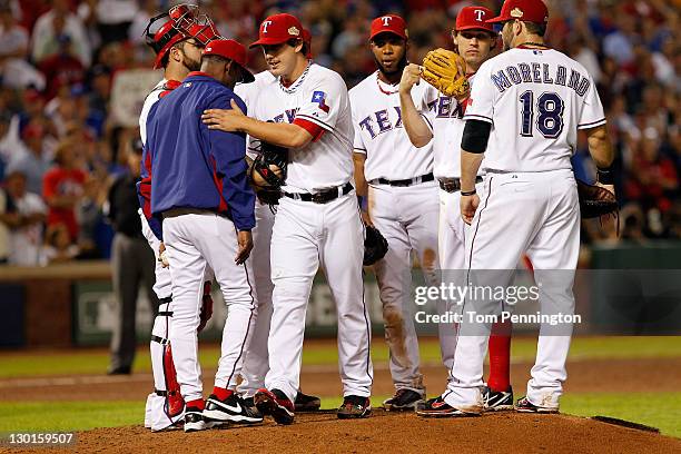 Derek Holland of the Texas Rangers is removed by manager Ron Washington in the ninth inning during Game Four of the MLB World Series against the St....