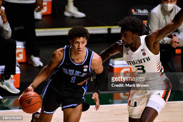 Jalen Johnson of the Duke Blue Devils drives to the basket against the Nysier Brooks of the Miami Hurricanes during the first half at Watsco Center...