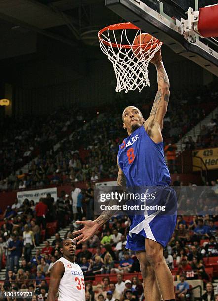 Michael Beasley of Team Blue goes to the net during the US Fleet Tracking Basketball Invitational charity basketball game October 23, 2011 at the Cox...