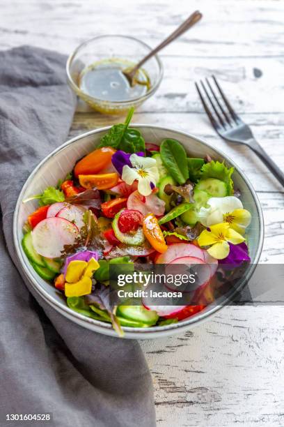 bowl of mixed salad with edible flowers - leaf lettuce stock pictures, royalty-free photos & images