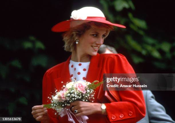 Diana, Princess of Wales, wearing a red jacket designed by Jan van Velden, with a white and red polka dot dress and a matching hat, visits Atlantic...