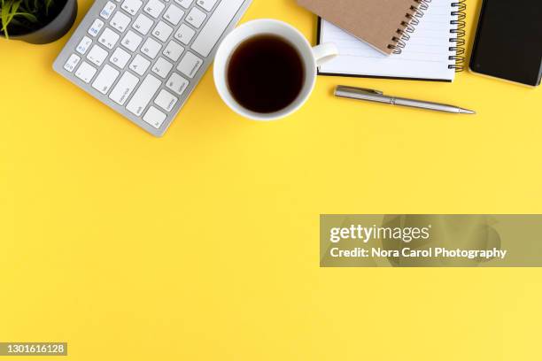 office desk on yellow background - phone plain background stock pictures, royalty-free photos & images