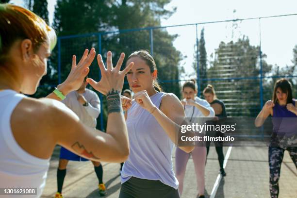 kickboxing class outdoors - women's self defense stock pictures, royalty-free photos & images