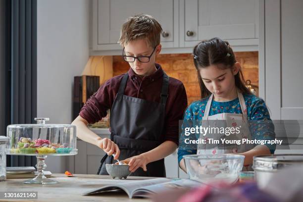 children making cake and baking - bruder schwester kochen stock-fotos und bilder