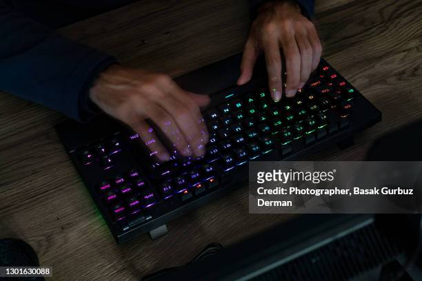 blurred motion of hands of a man typing on computer keyboard - fast typing stock pictures, royalty-free photos & images