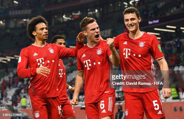 Joshua Kimmich of FC Bayern Muenchen celebrates with teammates Leroy Sane and Benjamin Pavard after scoring their team's first goal which was later...