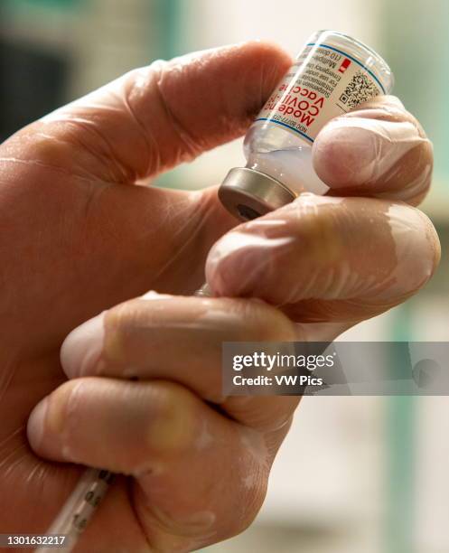 Moderna vaccine being drawn up into syringe, which was issued FDA emergency use authorization for the prevention of coronavirus disease. Florida, USA.