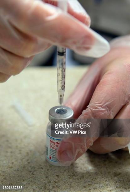 Moderna vaccine being drawn up into syringe, which was issued FDA emergency use authorization for the prevention of coronavirus disease. Florida, USA.