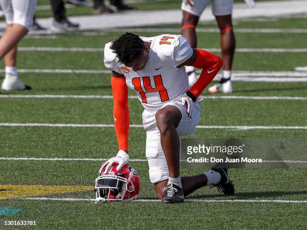Cornerback DJ Daniel from Georgia of the American Team takes a knee before the start of the 2021 Resse's Senior Bowl at Hancock Whitney Stadium on...