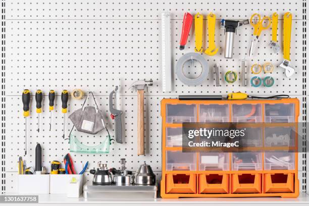 tools hanging on pegboard with toolbox - knolling tools stock-fotos und bilder