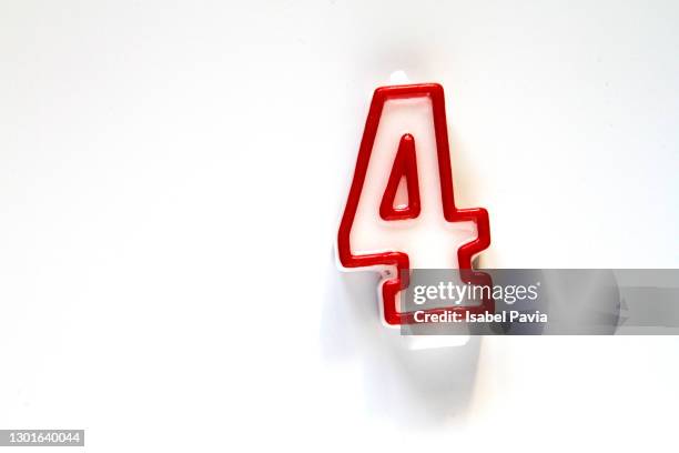 birthday candles number four on white - birthday candle number stock pictures, royalty-free photos & images