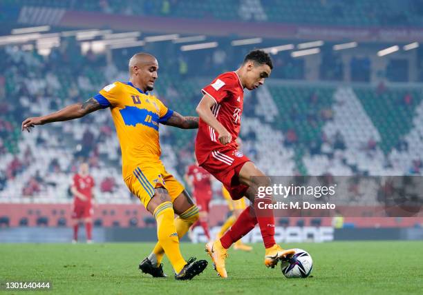 Jamal Musiala of Muenchen is challenged by Luis Rodriguez of Tigres UANL during the FIFA Club World Cup Qatar 2020 final between Bayern Muenchen and...