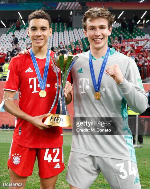 Jamal Musiala and Lukas Schneller of Muenchen pose with the trophy after winning during the FIFA Club World Cup Qatar 2020 final between Bayern...