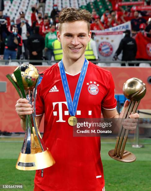 Joshua Kimmich of Muenchen poses with the FIFA Club World Cup Qatar 2020 trophy and the adidas bronze ball after winning the FIFA Club World Cup...