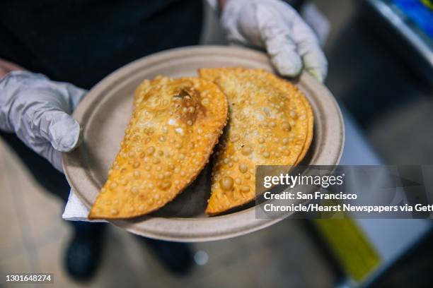 Freshly-made empanadillas are seen on a plate at La Perla in the Lower Dimond neighborhood of Oakland, Calif. On Wednesday, Feb. 10, 2021. Scheduled...