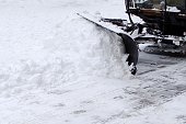 snowblower on footpath in the city