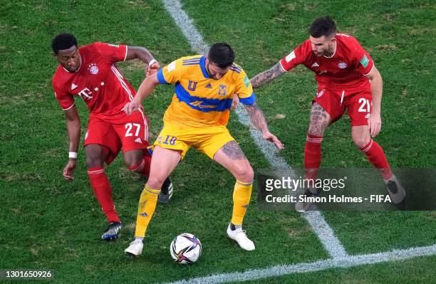 Andre-Pierre Gignac of Tigres UANL looks to break past David Alaba of FC Bayern Muenchen and Lucas Hernandez of FC Bayern Muenchen during the FIFA...