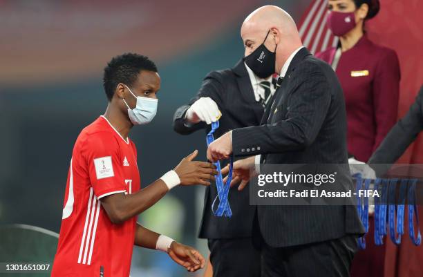 Bouna Sarr of FC Bayern Muenchen interacts with Gianni Infantino, President of FIFA as he collects his winners medal during the presentation ceremony...